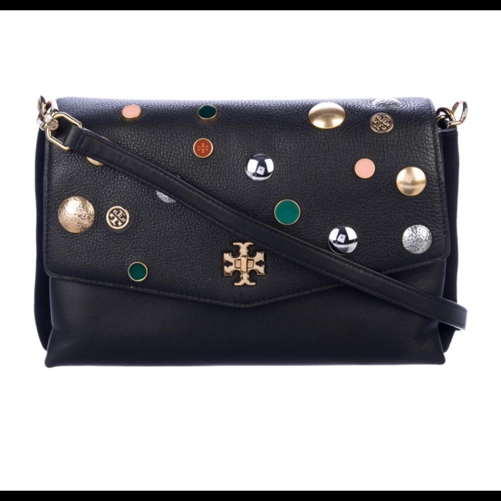 Tory Burch—100% leather. This bag has lots of room, three pockets.